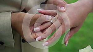 Bride and groom at wedding ceremony. Man put on a ring on a woman finger.