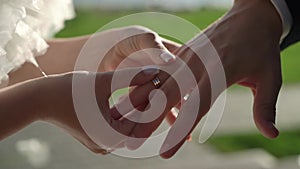 Bride and groom at wedding ceremony. Man put on a ring on a woman finger.