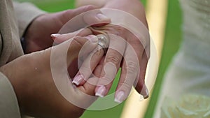 Bride and groom at wedding ceremony. Man put on a ring on a woman finger.