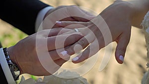 Bride and groom at wedding ceremony. Man put on a ring on a woman finger.