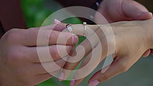 Bride and groom at wedding ceremony. Man put on a ring on a woman finger.