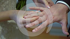 Bride and groom at wedding ceremony. Man put on a ring on a woman finger.