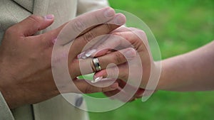 Bride and groom at wedding ceremony. Man put on a ring on a woman finger.