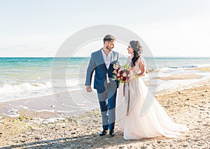 Bride and groom at wedding ceremony near sea