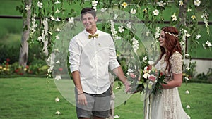 Bride and groom at wedding ceremony. Tropical garden at the evening. Lovely newlyweds couple
