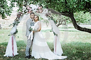 The bride and groom at the wedding ceremony are in the wedding arch. selective focus.