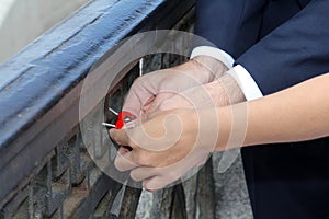 Bride and groom on wedding day hang a wedding lock