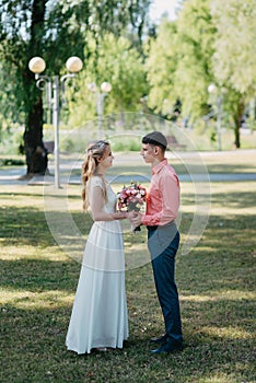 Bride and groom at wedding Day walking Outdoors on spring nature. Bridal couple, Happy Newlywed woman and man embracing