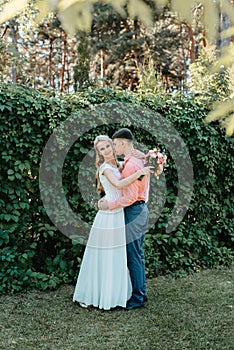 Bride and groom at wedding Day walking Outdoors on spring nature. Bridal couple, Happy Newlywed woman and man embracing