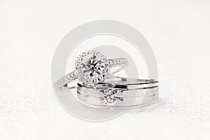 Bride and groom wedding engagement rings on white background