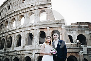 Bride and groom wedding poses in front of Colosseum, Rome, Italy