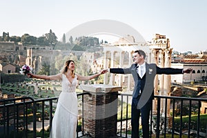 Bride and groom wedding poses in front of Roman Forum, Rome, Italy