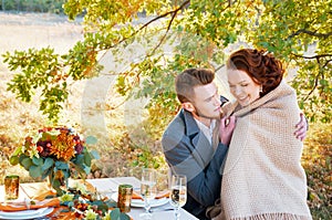Bride and groom at the wedding table. Autumn outdoor setting.