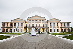 Bride and groom at wedding walk near palace