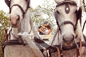 Bride and groom in a white carriage