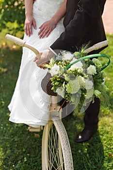 Bride and groom with a white wedding bike