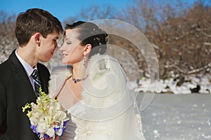 bride and groom in the winter lake