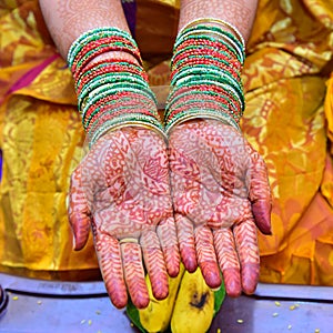 Bride hands with full of Mehndi and bangles