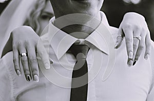 Bride hands on groom shoulders