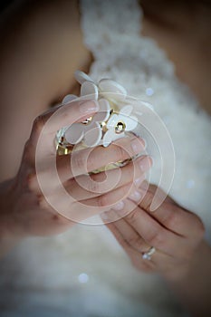 Bride hands holding bottle of Daisy perfume