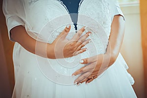 Bride hands holding her wedding dress