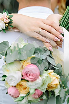 Bride hands with wedding flower bouquet close up