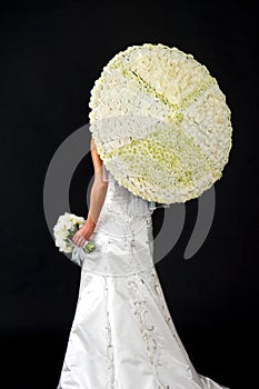 Bride with her bouquet and floral parisol