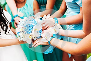 A bride and her bridesmaids holding flowers