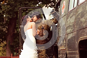 Bride with her groom wearing army suit