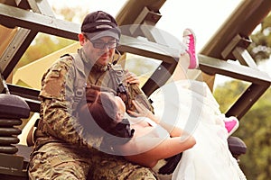 Bride with her groom wearing army suit