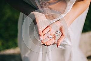 Bride in her hands holding a ring and small cubes with letters that form the inscription love