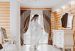 The bride in her stylish room, preparing for the wedding. A girl in a dressing gown