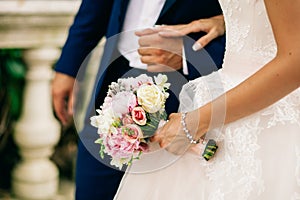 Bride hold wedding bouquet of rose peonies and roses