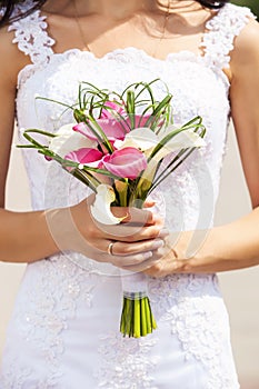 Bride holding bouquet of deep-bo