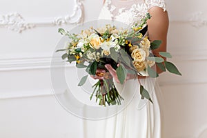 Bride holding a bouquet of flowers in a rustic style, wedding bouquet