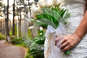 Bride holding colorful elegant modern autumn wedding bouquet. The concept of lifestyle and autumn wedding.