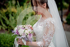 Bride holding colorful elegant modern autumn wedding bouquet. The concept of lifestyle and wedding