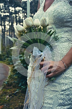 Bride holding colorful elegant modern autumn wedding bouquet. The concept of lifestyle and autumn wedding.