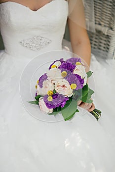 Bride holding delicate marriage bouquet