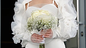 Bride holding gentle wedding bouquet