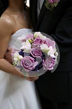 Bride holding her bouquet with groom