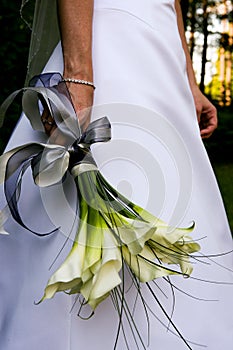 Bride holding her wedding Bouquet by her side