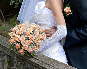 Bride holding orange bouquet detail