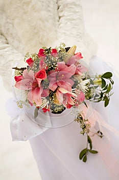 The bride holding pink wedding bouquet