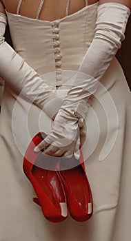 A bride holding Red Shoes