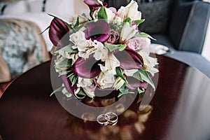 The bride holding soft wedding bouquet of roses, peonies and eustoma, horizontal shot