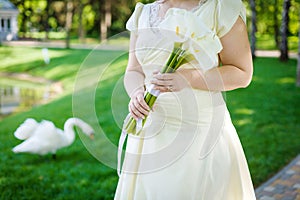 Bride holding wedding bouquet from calla