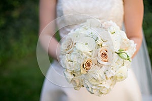 Bride holding wedding bouquet of pink and white flowers
