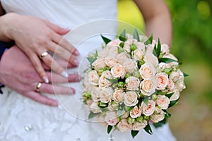 The bride holding wedding bouquet of pink and white roses