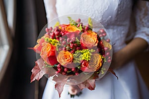 Bride holding wedding Colorful bouquet of autumn flowers